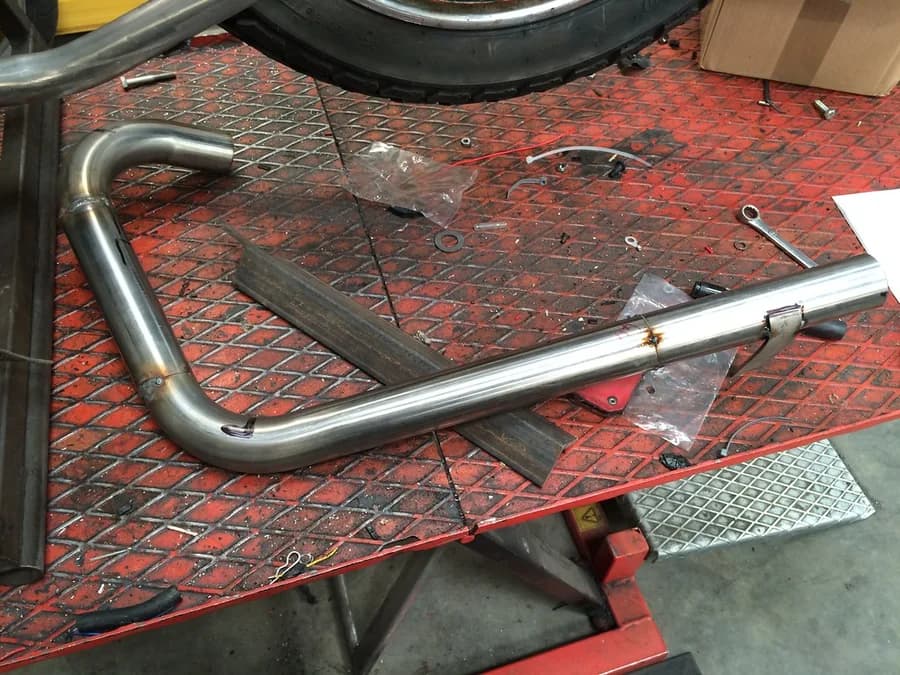 Bent metal tubes arranged on a fabrication workbench