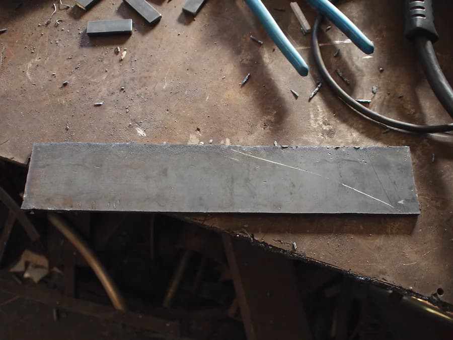 Steel plate blank on a metalworking bench