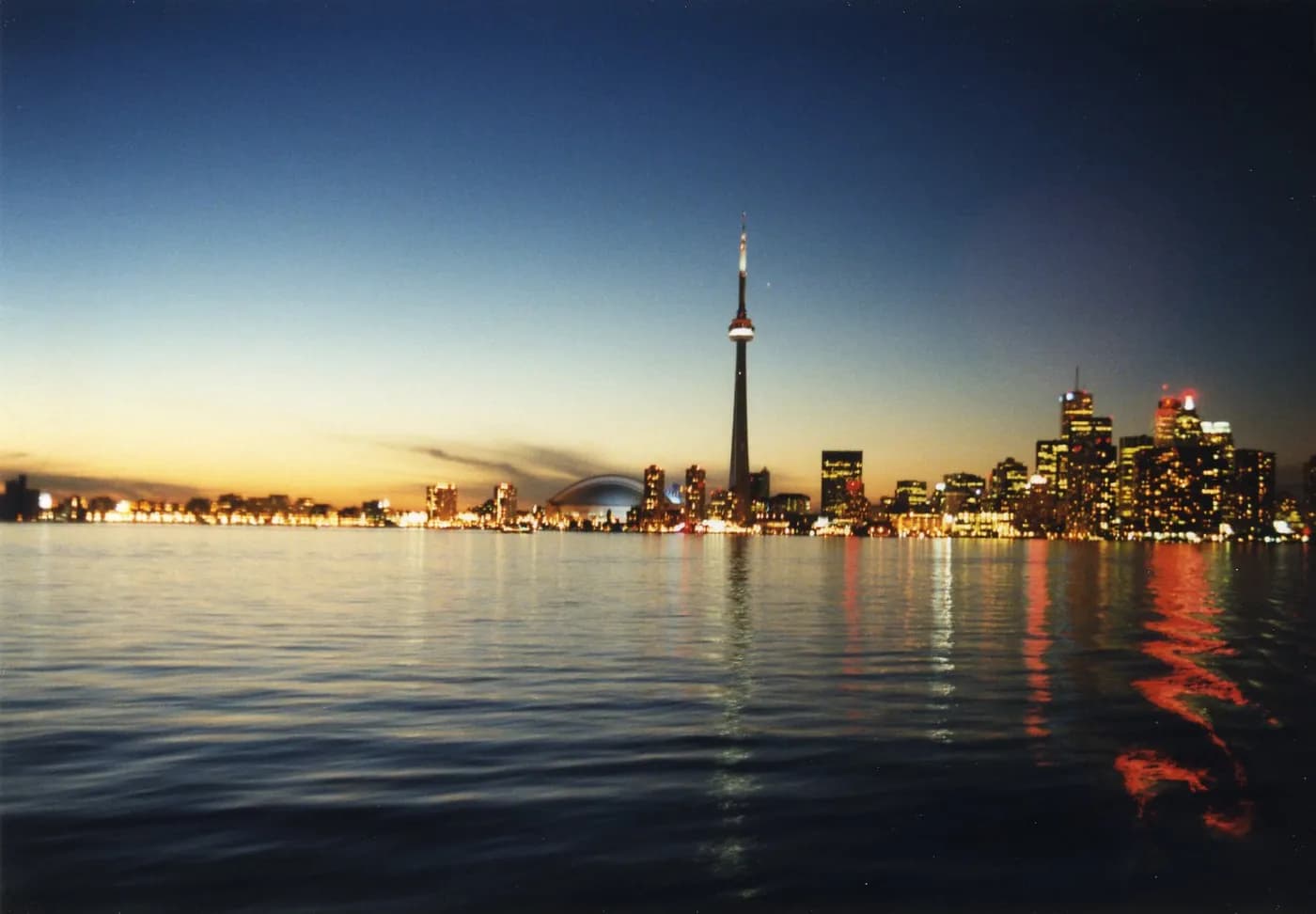 Toronto skyline across the waterfront at dusk