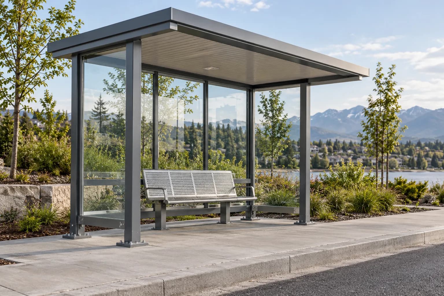 Graphite metal passenger shelter with glazed sides and a perforated metal bench