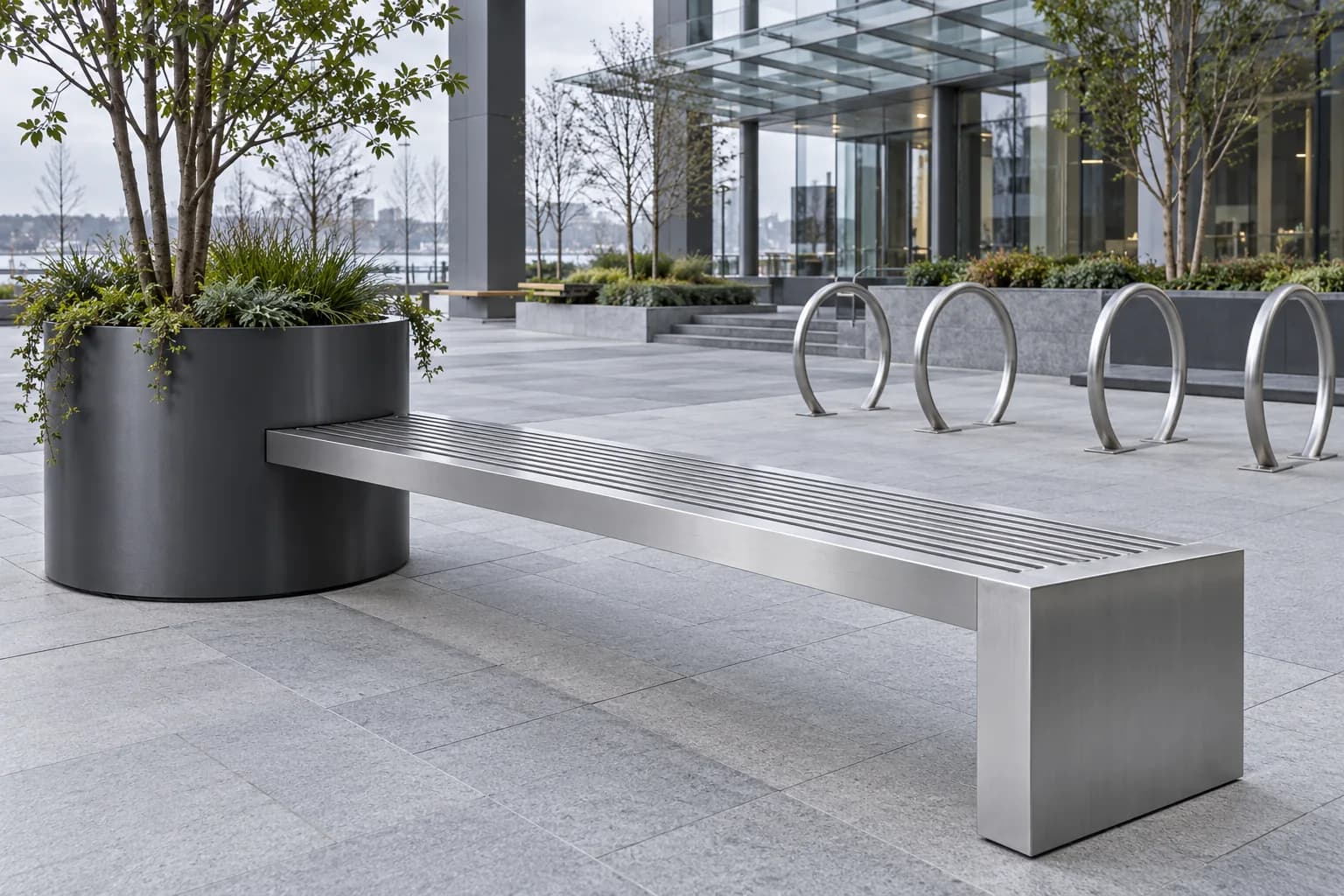Metal seating, a circular planter and bicycle parking loops in a civic courtyard