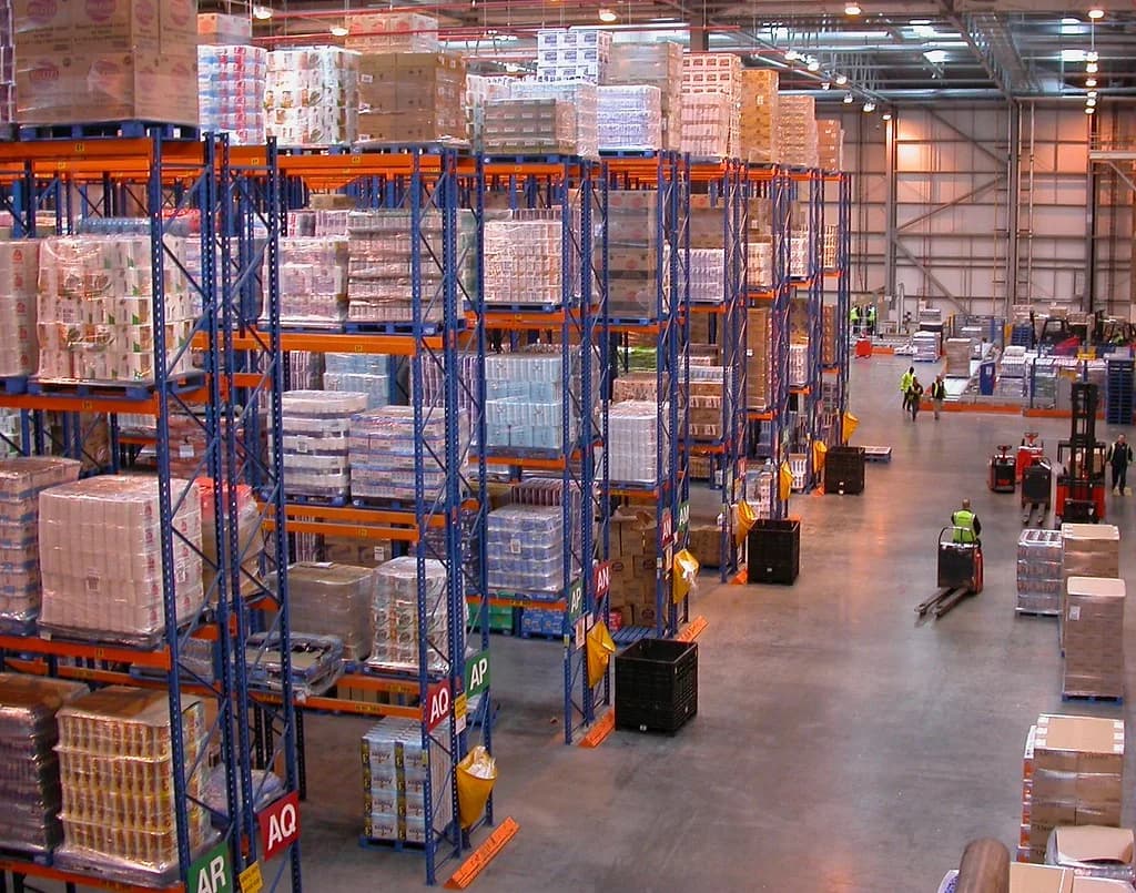 Industrial warehouse aisles with tall steel storage racks