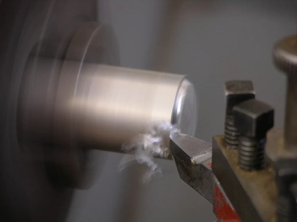 Metal stock being turned on a lathe